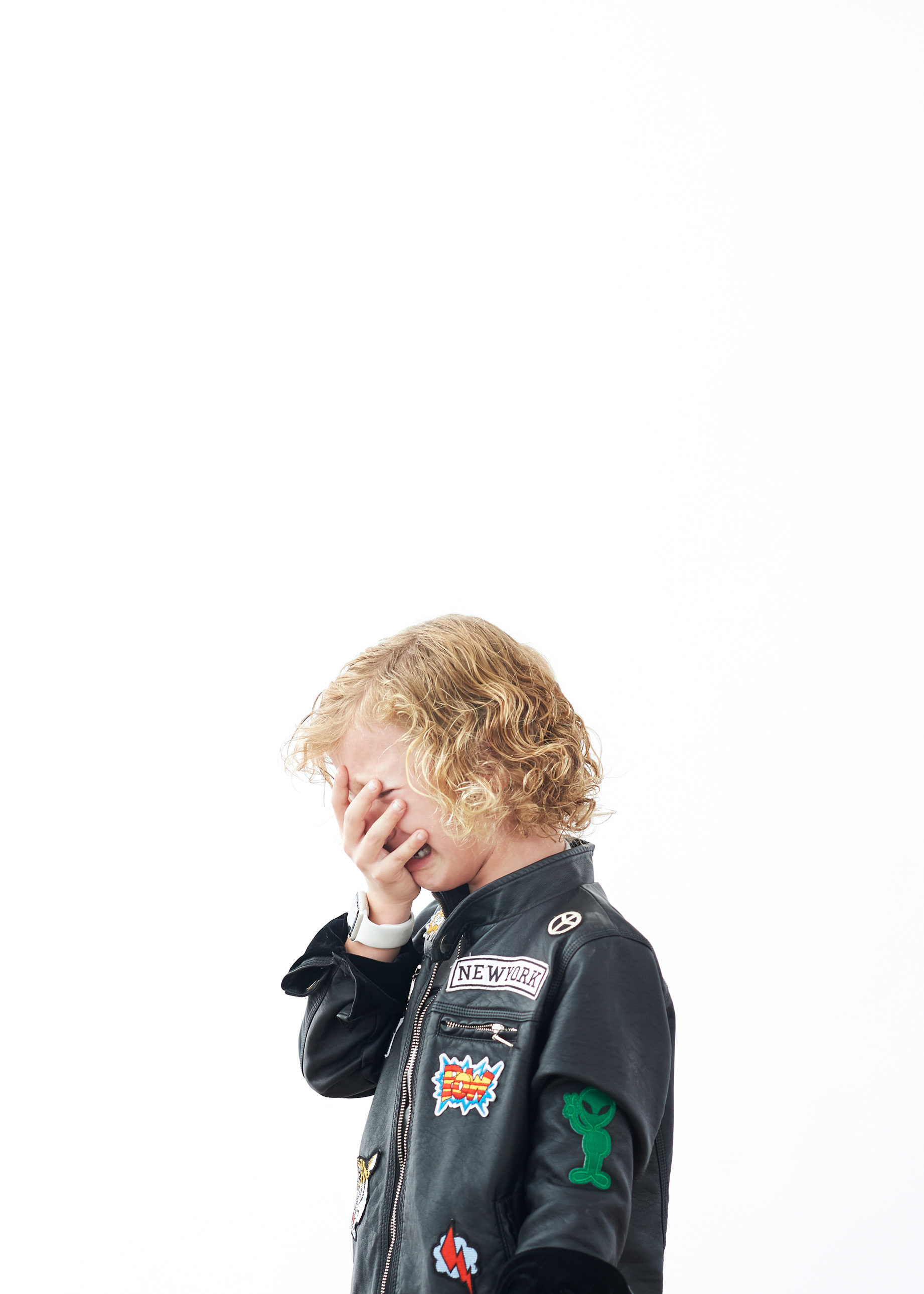 boy crying in leather motorcycle jacket