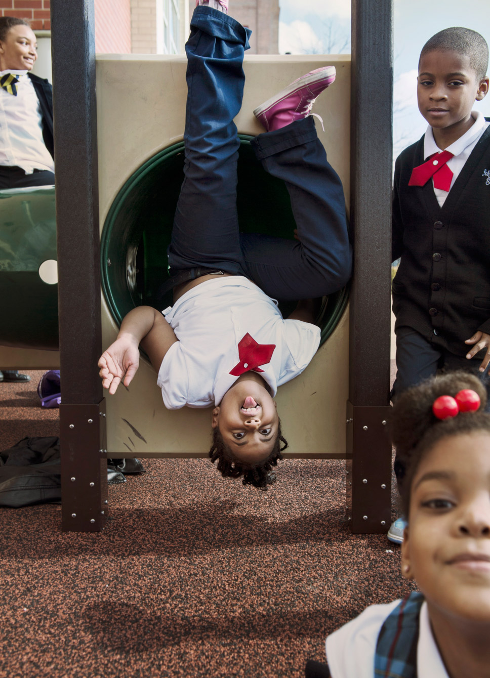 kids upside down on playground jungle gym