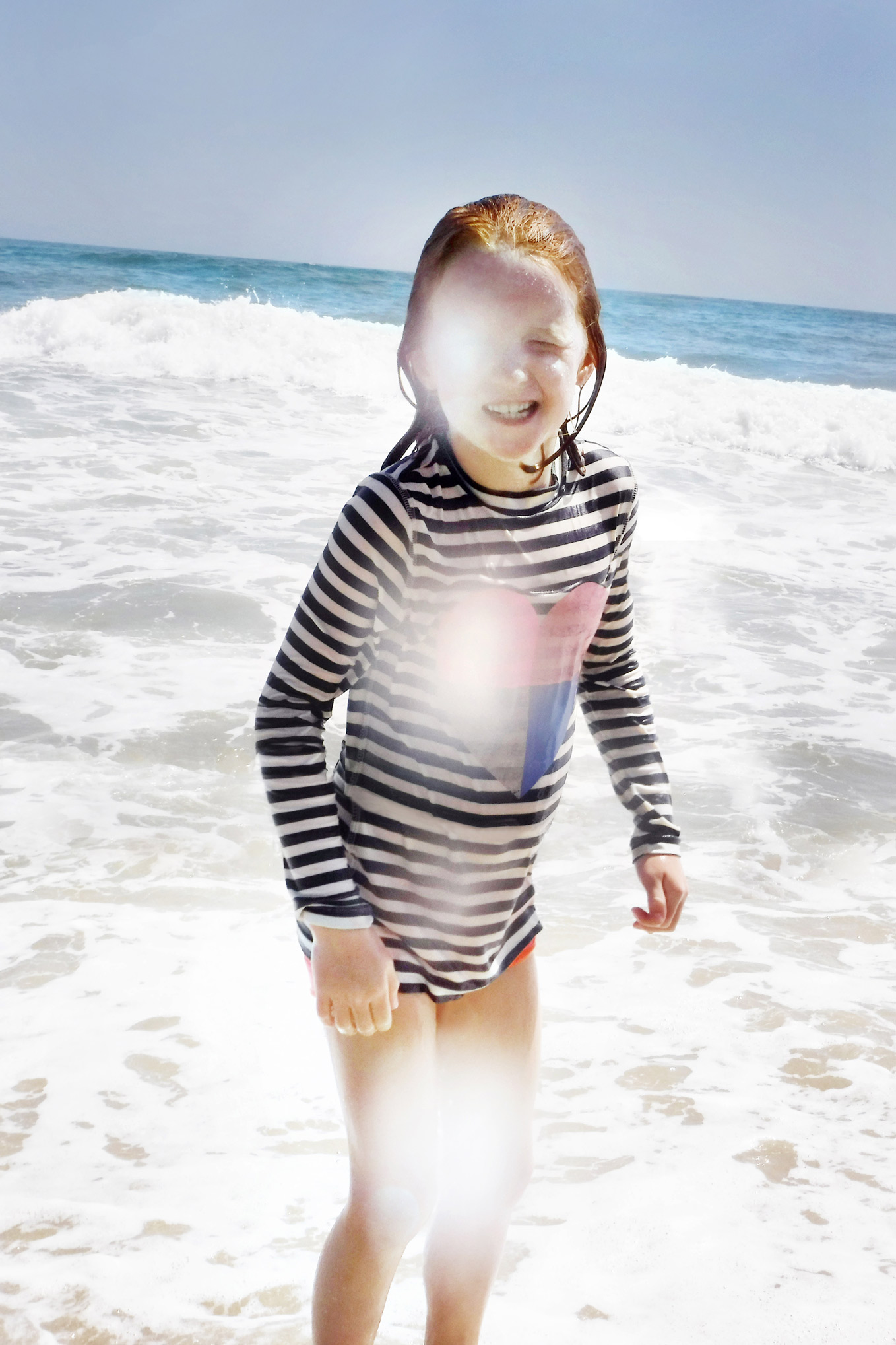 girl in ocean with water spot