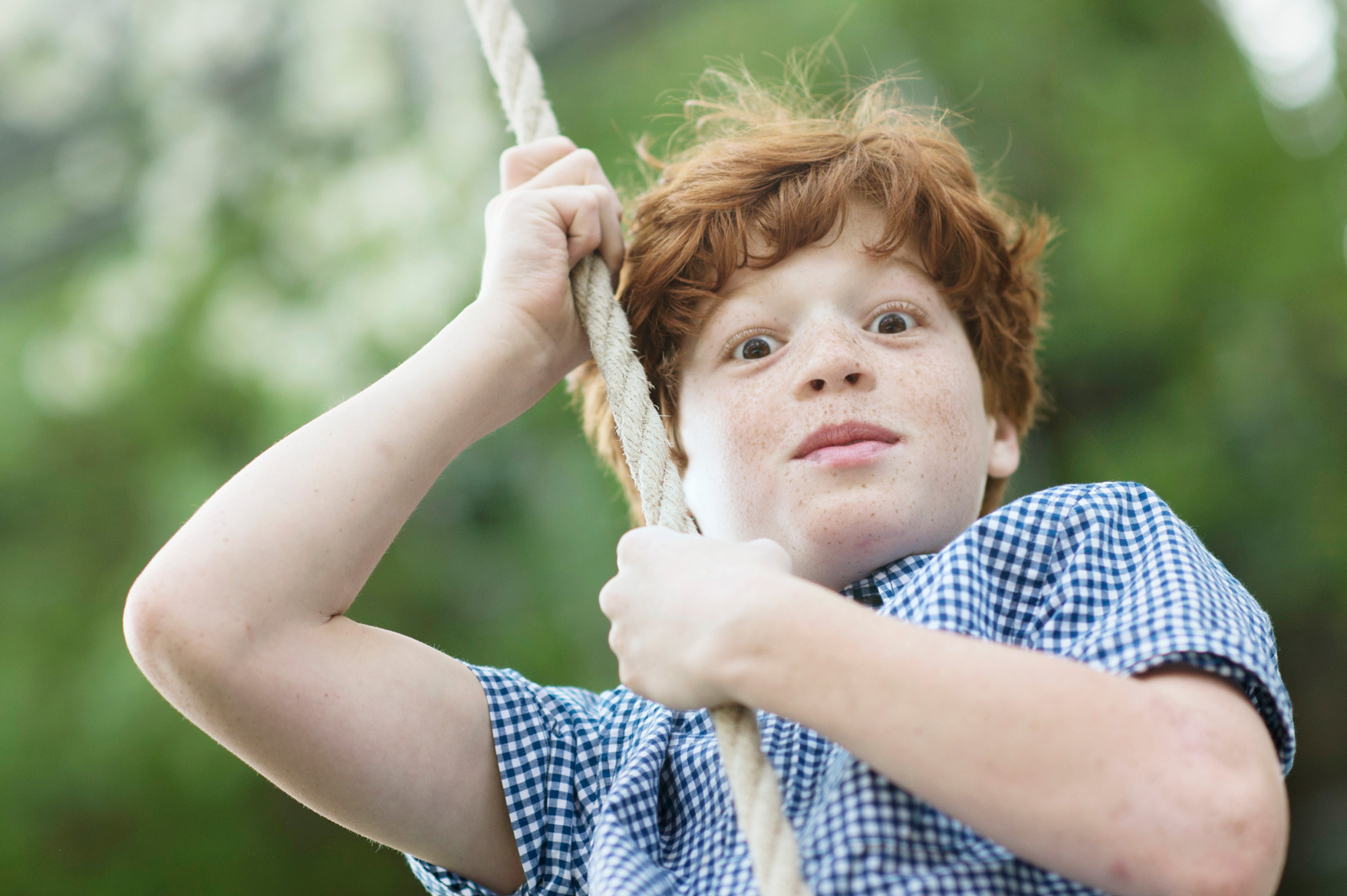 red haired boy on swing
